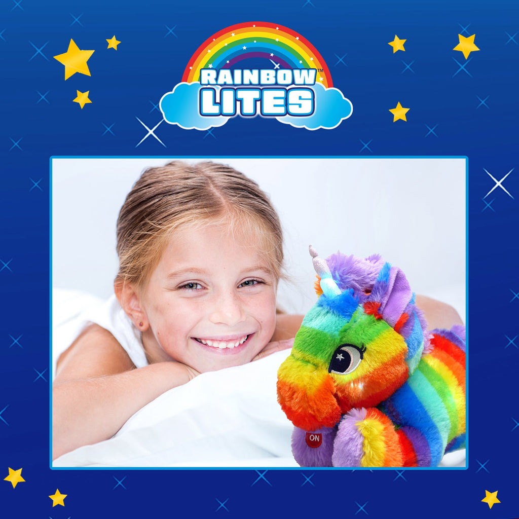 Smiling child in bed beside the glowing rainbow unicorn plush under the Rainbow Lites logo.