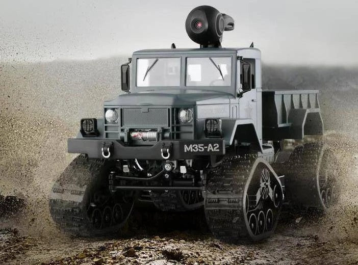 Gray-blue camera-equipped truck on a rocky surface