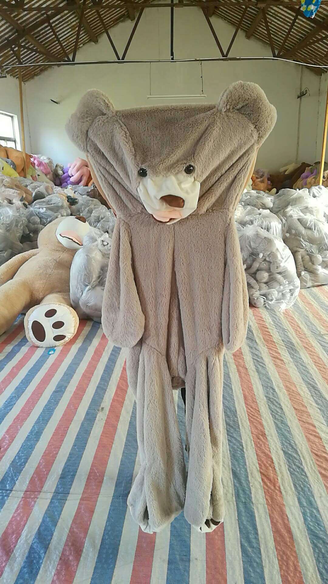 The giant teddy bear plush toy in playful arrangement