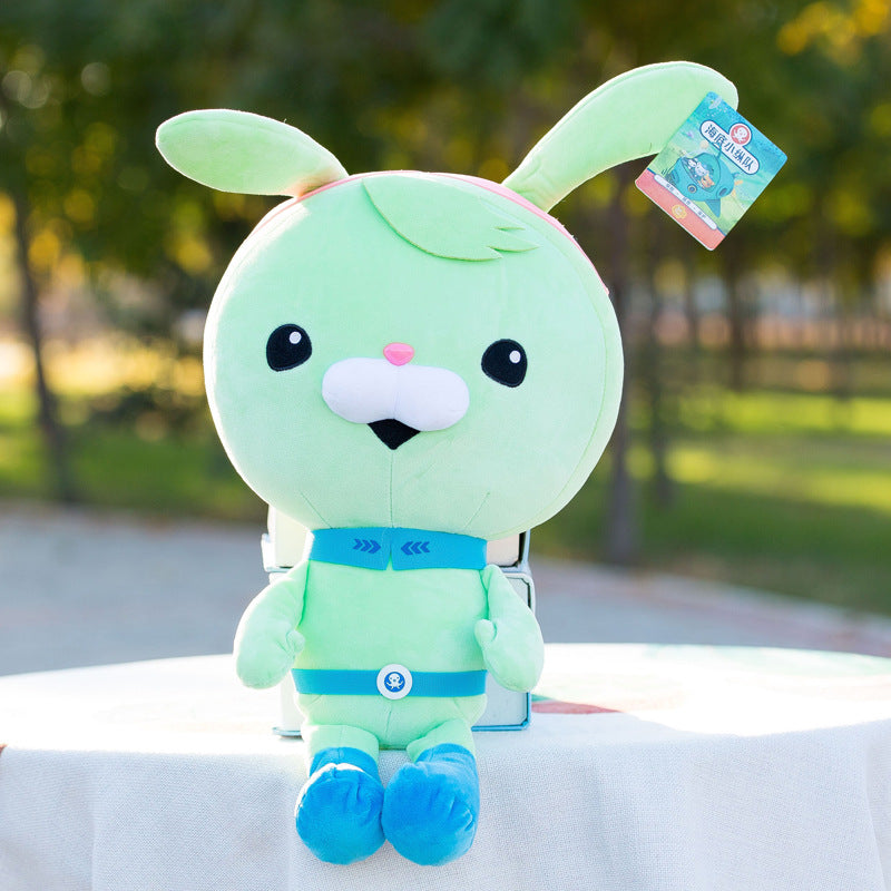 Green bunny-eared cartoon character plush with a big round head and blue belt