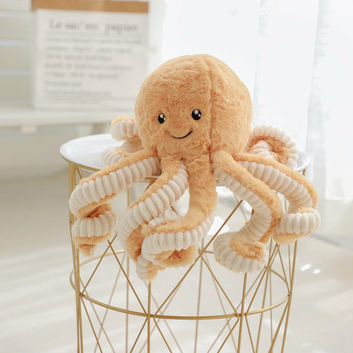 Tan curly-tentacled octopus plush perched on a wire basket