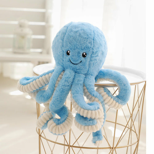 Blue curly-tentacled octopus plush perched on a wire basket