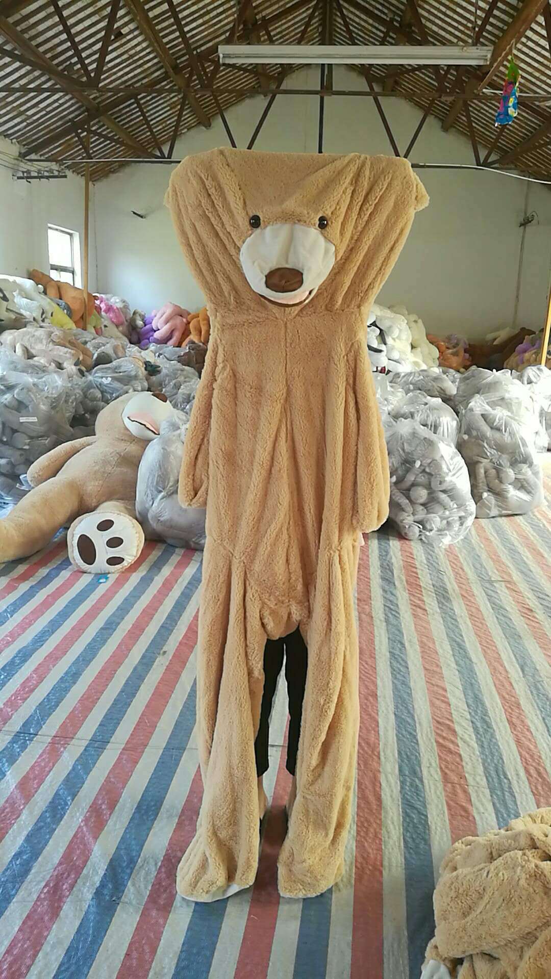 Side view of the giant teddy bear plush toy