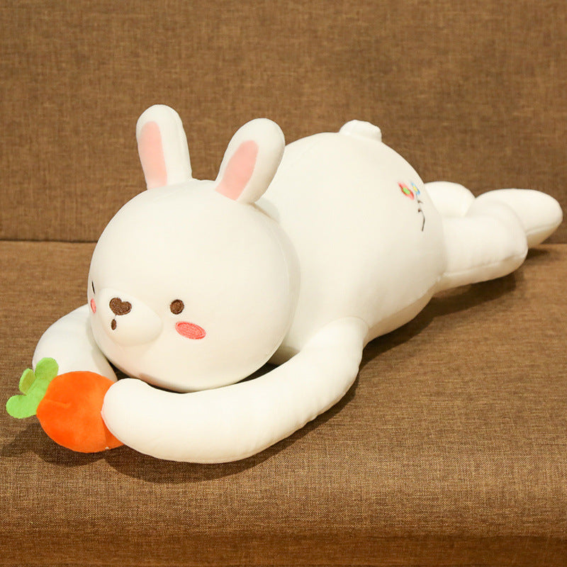 White rabbit plush holding a carrot, hugged on a couch