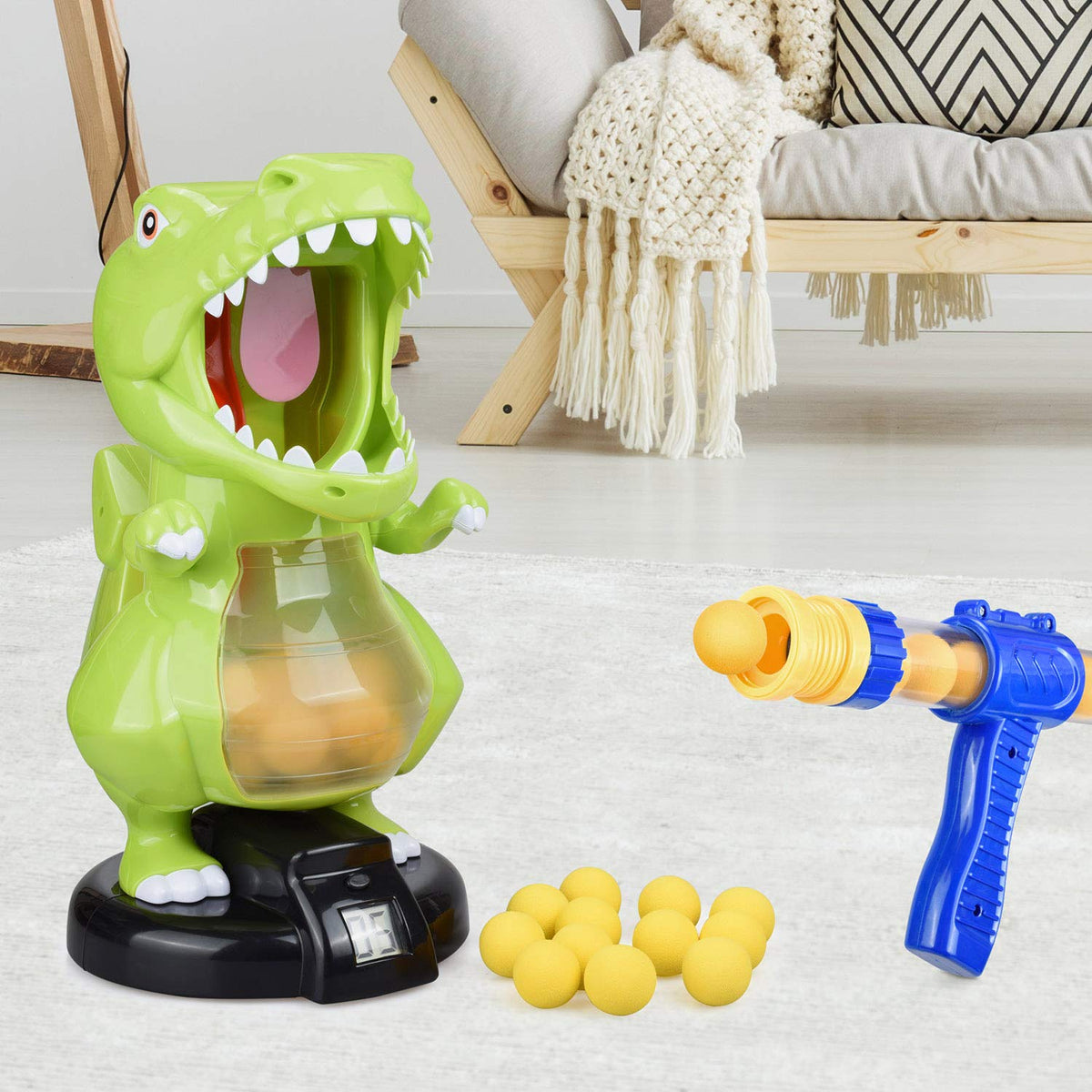 Dinosaur target and blaster arranged beside a sofa