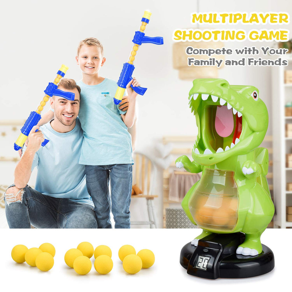 Adult and child holding foam-ball blasters beside dinosaur target