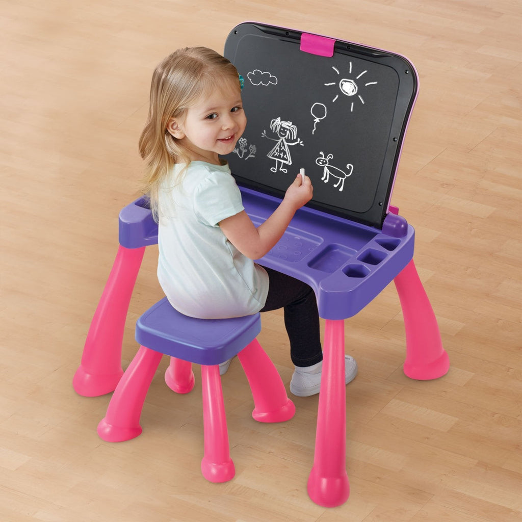 Child drawing on the upright chalkboard surface