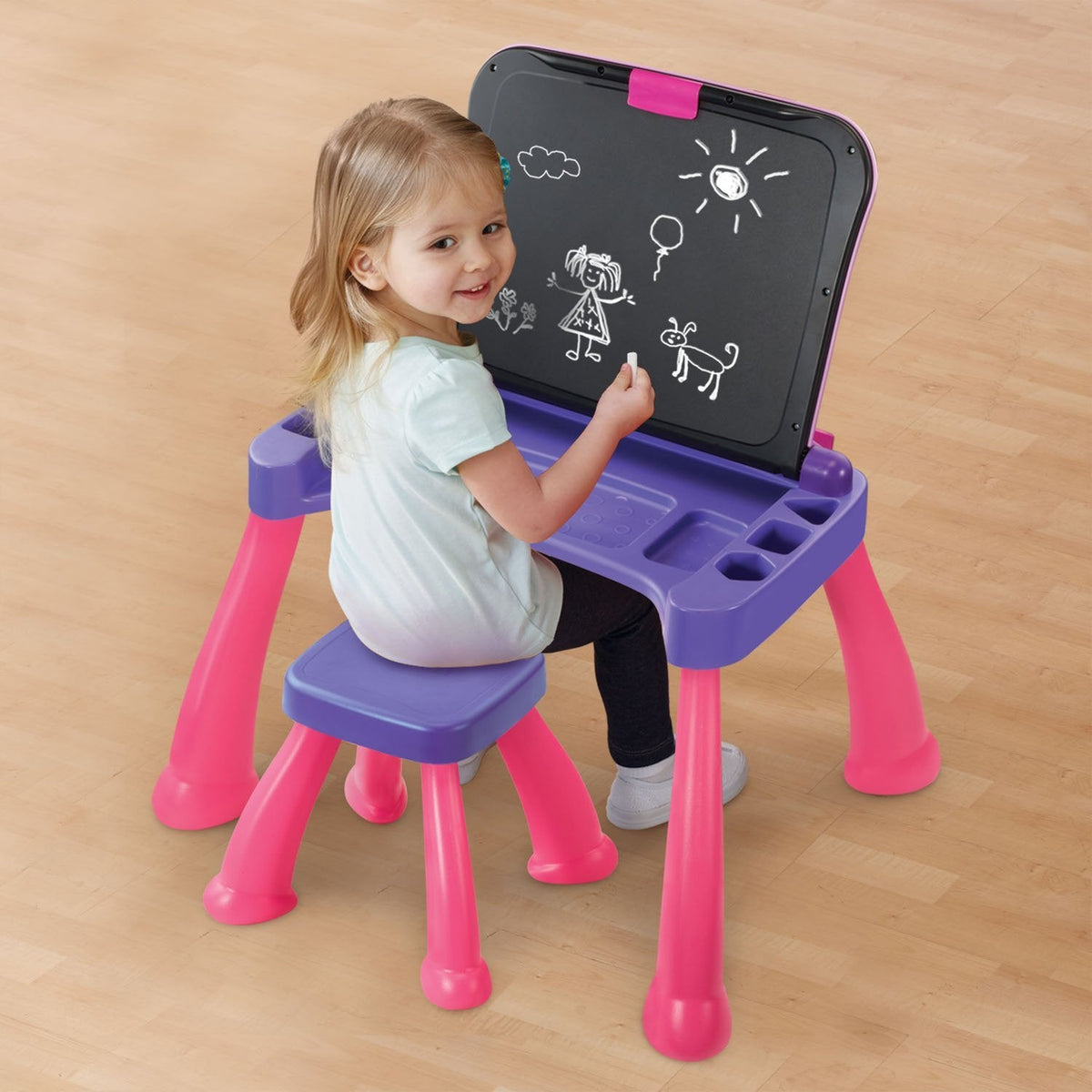Child drawing on the upright chalkboard surface