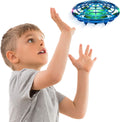 Child guiding a blue guarded UFO drone above an open hand