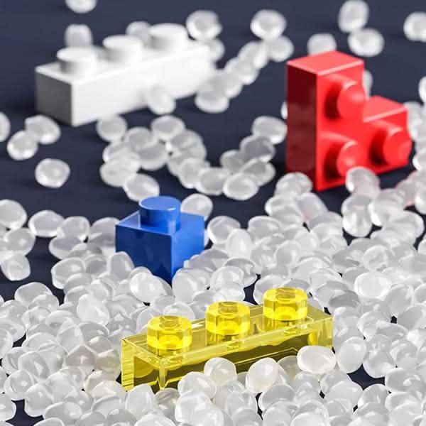 Close-up of colorful micro building blocks scattered beside standard bricks.