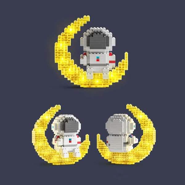Three views of the completed astronaut on the glowing crescent moon base.