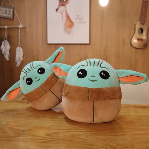 Two green-eared plush characters on a wooden tabletop