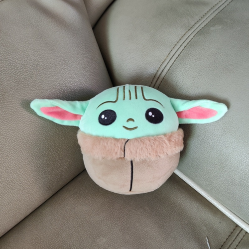 Front view of green-eared plush on a sofa