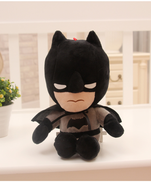 Black Batman plush seated on a shelf