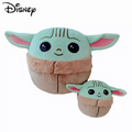 Green big-eared Grogu-style plush characters in tan robes