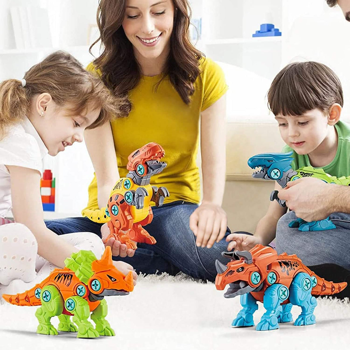 Family playing with the assembled take-apart dinosaurs and tools.