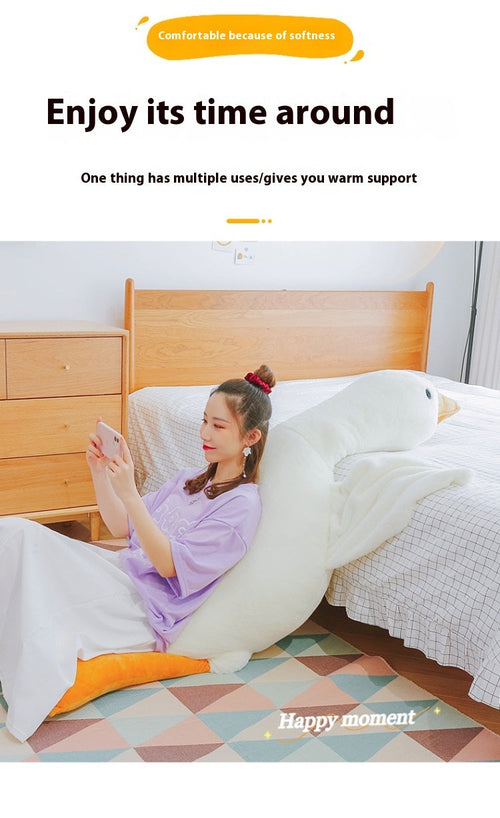Person reclining with a long goose plush pillow