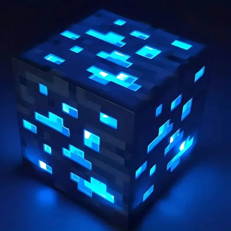 Glowing blue pixel ore block night light photographed in the dark.