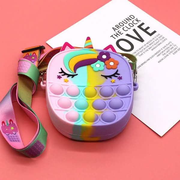 unicorn pop-it crossbody purse arranged for display